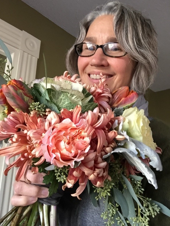 Kathe Mickunas holding floral bouquet