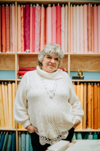 Susan standing in front of her fabric