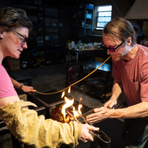 photo of glassworkers creating together