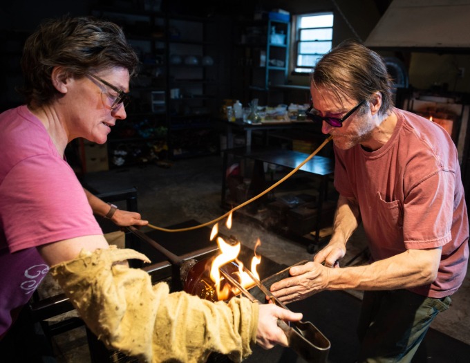 photo of glass blowers and fire