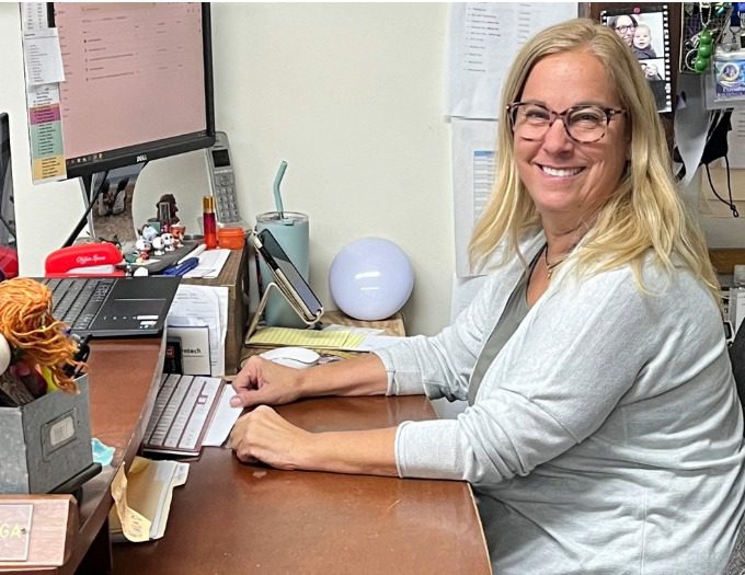 photo of Diane Madruga working at her computer