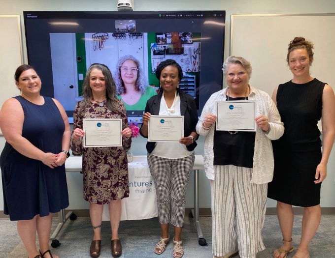 Four Venturing Forth class graduates are joined by NVME microenterprise specialsts Destin DeCambre and Martha Leonard.
