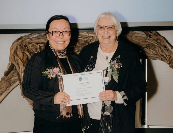 Joyce Jiang_Gilda Nardone_MIH 2026 Joyce and Gilda stand together holding Joyce's certificate and smiling